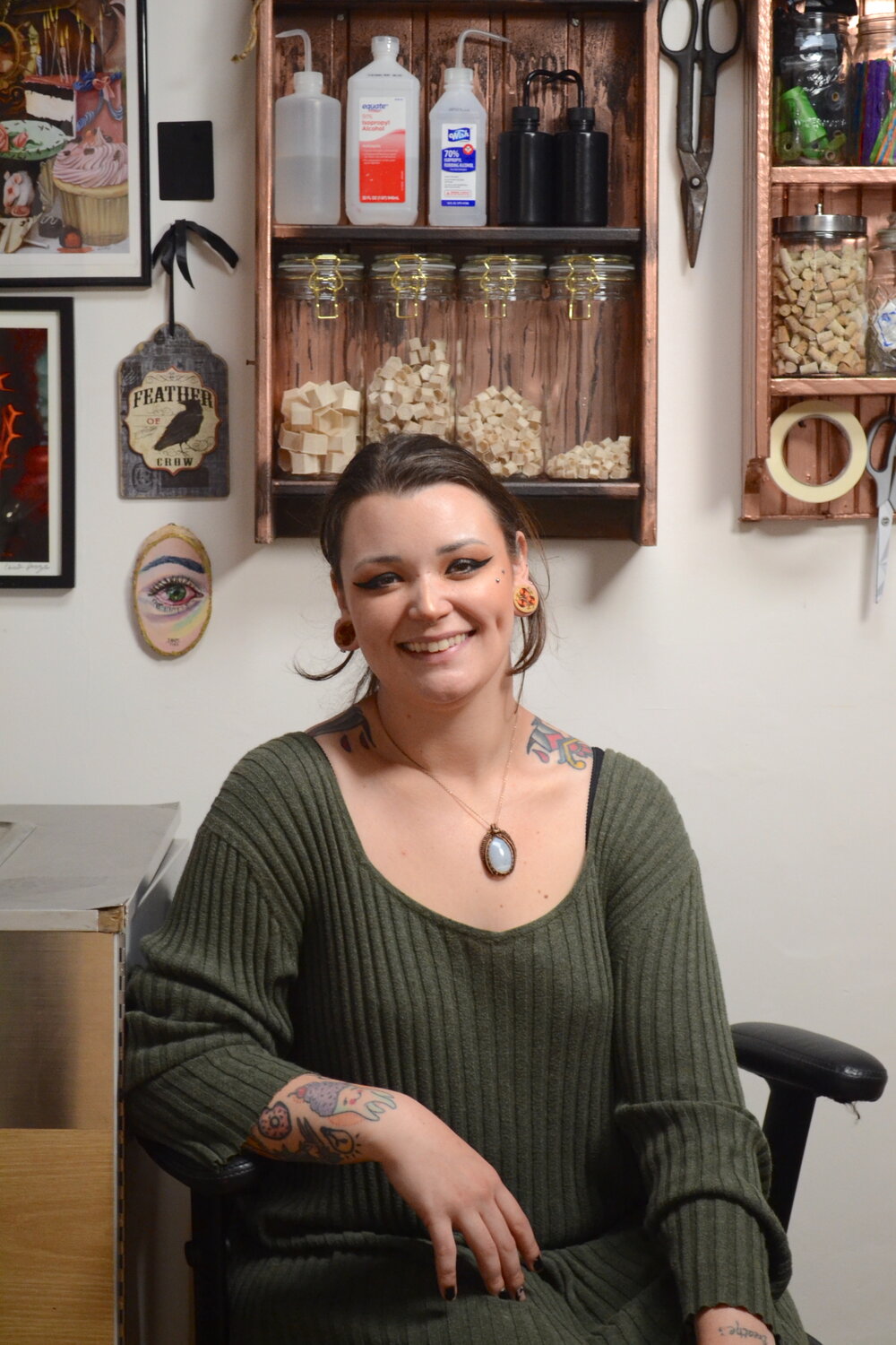 Chrystal Santos sits in her office at Eclectic Body Art, located at 446 Main St. in Warren.