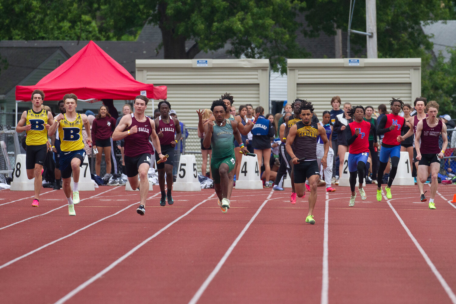 Runners sprint the final 100 meters in the 4x100 at the state track championship on Saturday.