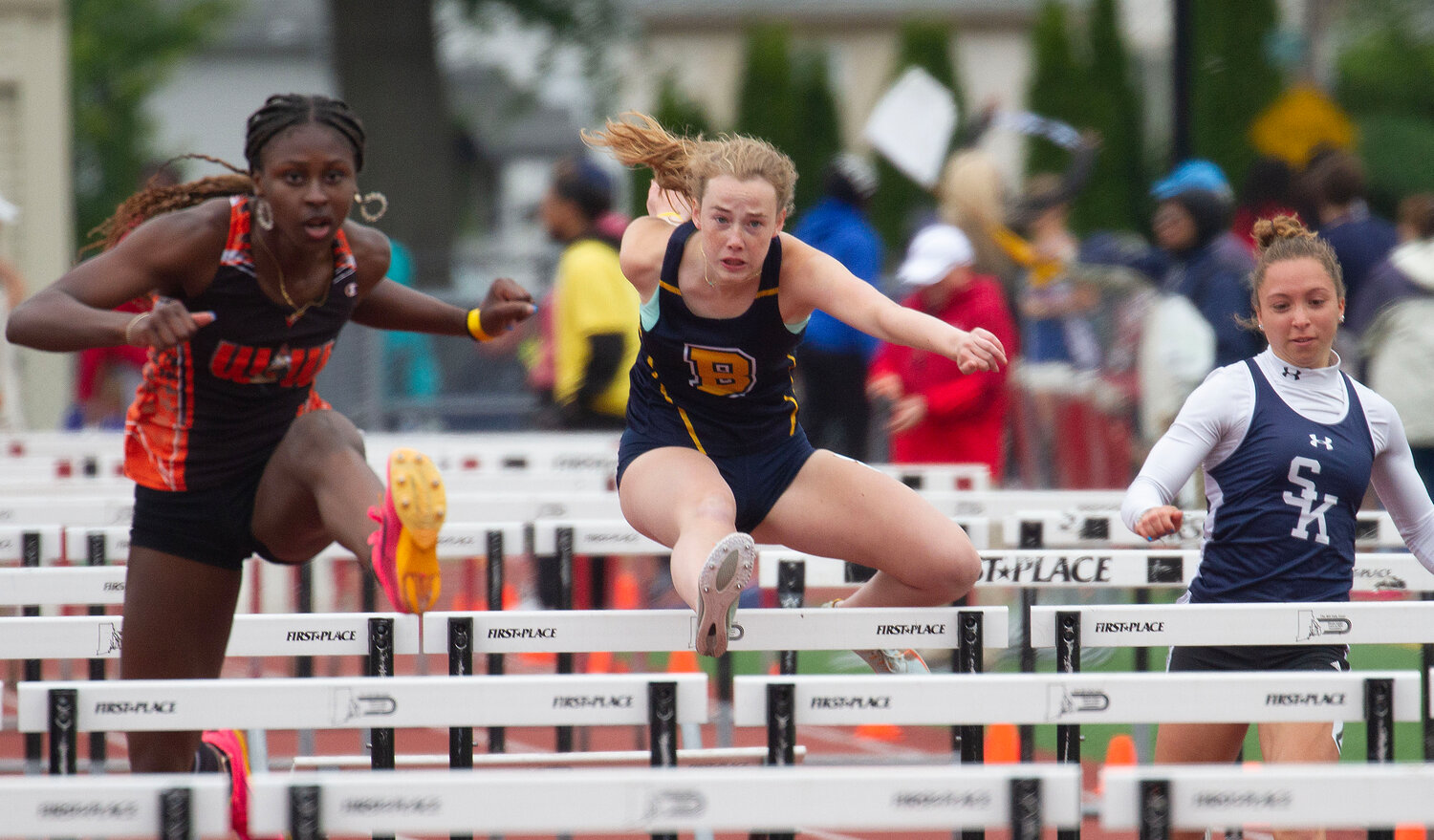 Barrington's Jordan Roskiewicz (center) competes in the 100-meter hurdles at the state track meet.