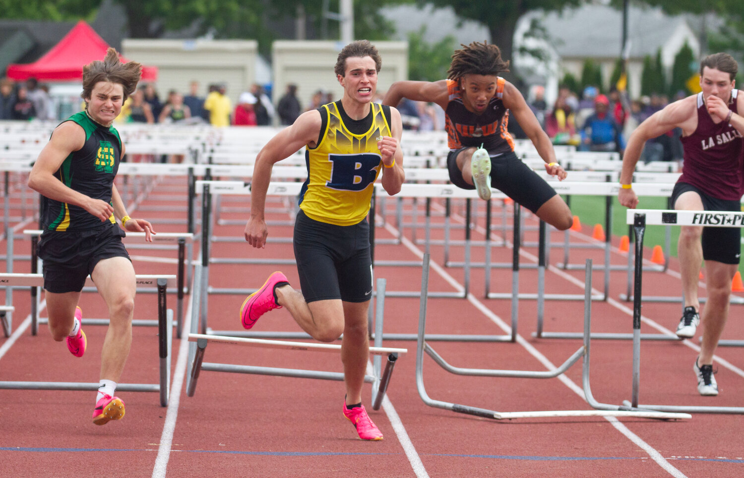 Barrington's Ethan Knight (center) pushes over the final hurdle in the 110-meter hurdles event at the state track meet.