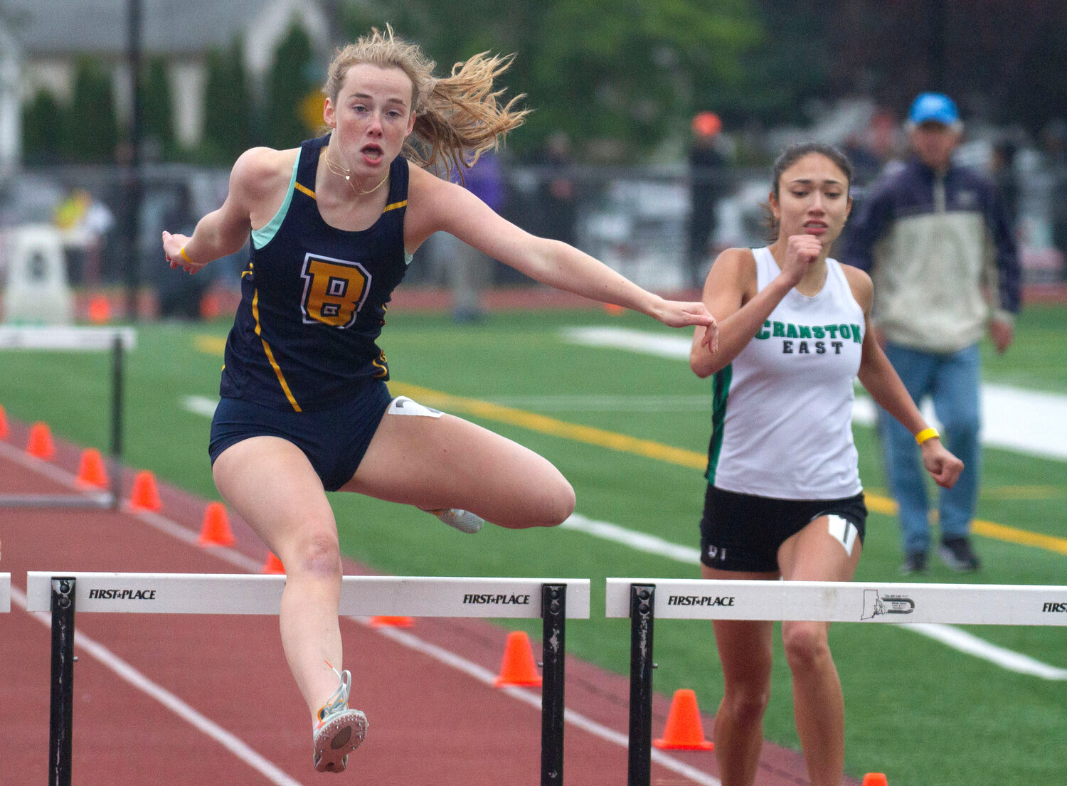 Barrington's Jordan Roskiewicz (left) clears a hurdle in the 300-meter hurdles race at states.