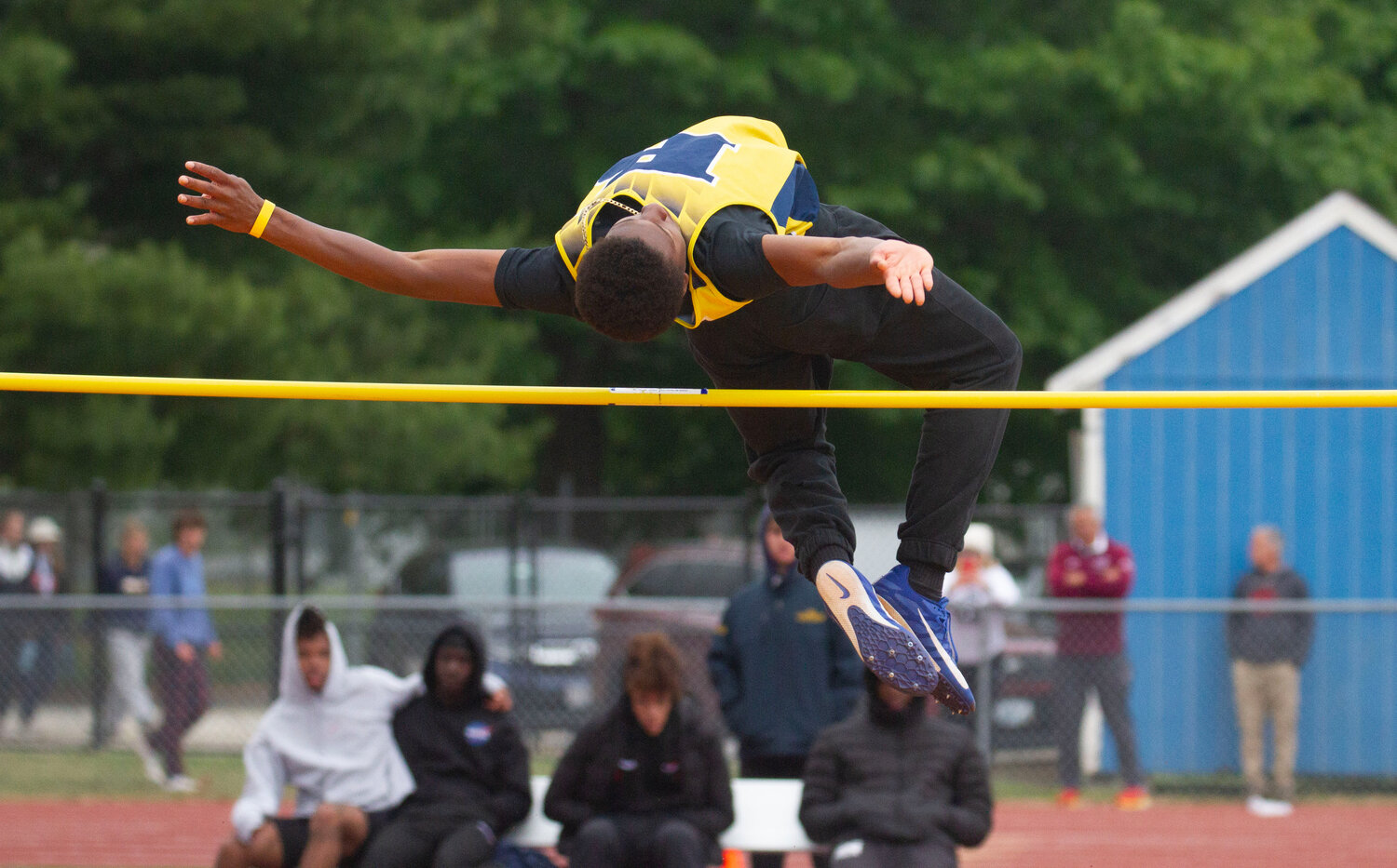 Barrington's Caleb Satisfield easily clears the bar in the high jump at the state track meet.
