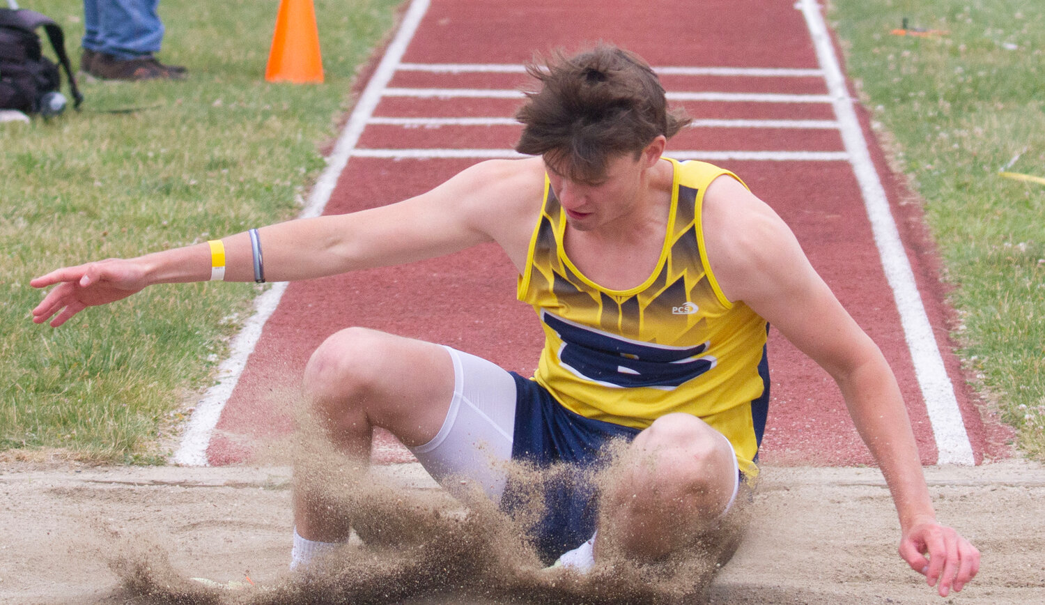 A Barrington student-athlete competes in the long jump.