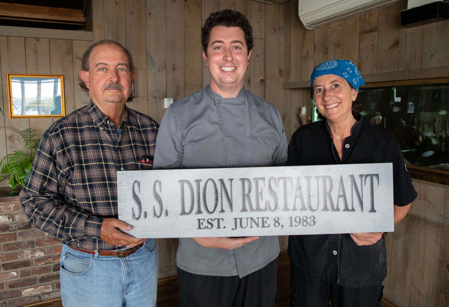 Steve and Sue Dion, left and right, with their son, Nic, are celebrating 40 years at S.S. Dion.