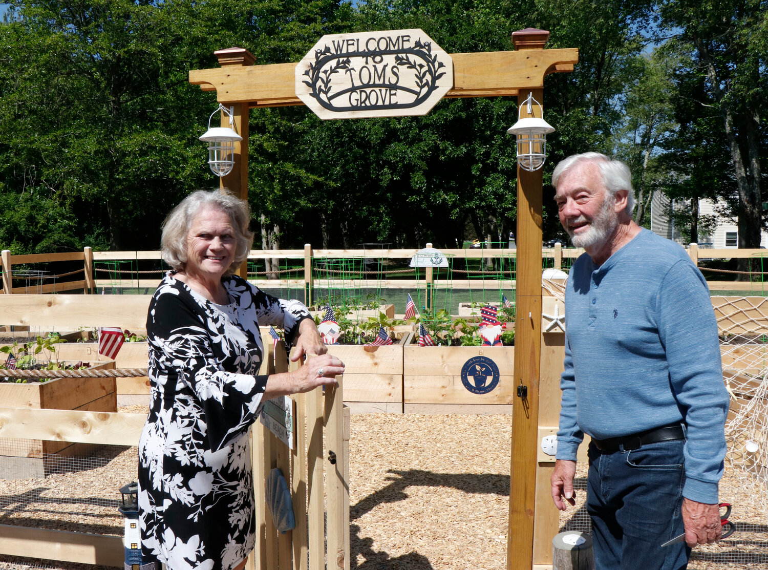 Garden co-coordinators Linda Heroux and Rick Hunter cut the ribbon at the dedication of the Tom’s Grove Memorial garden on Wednesday, May 31.