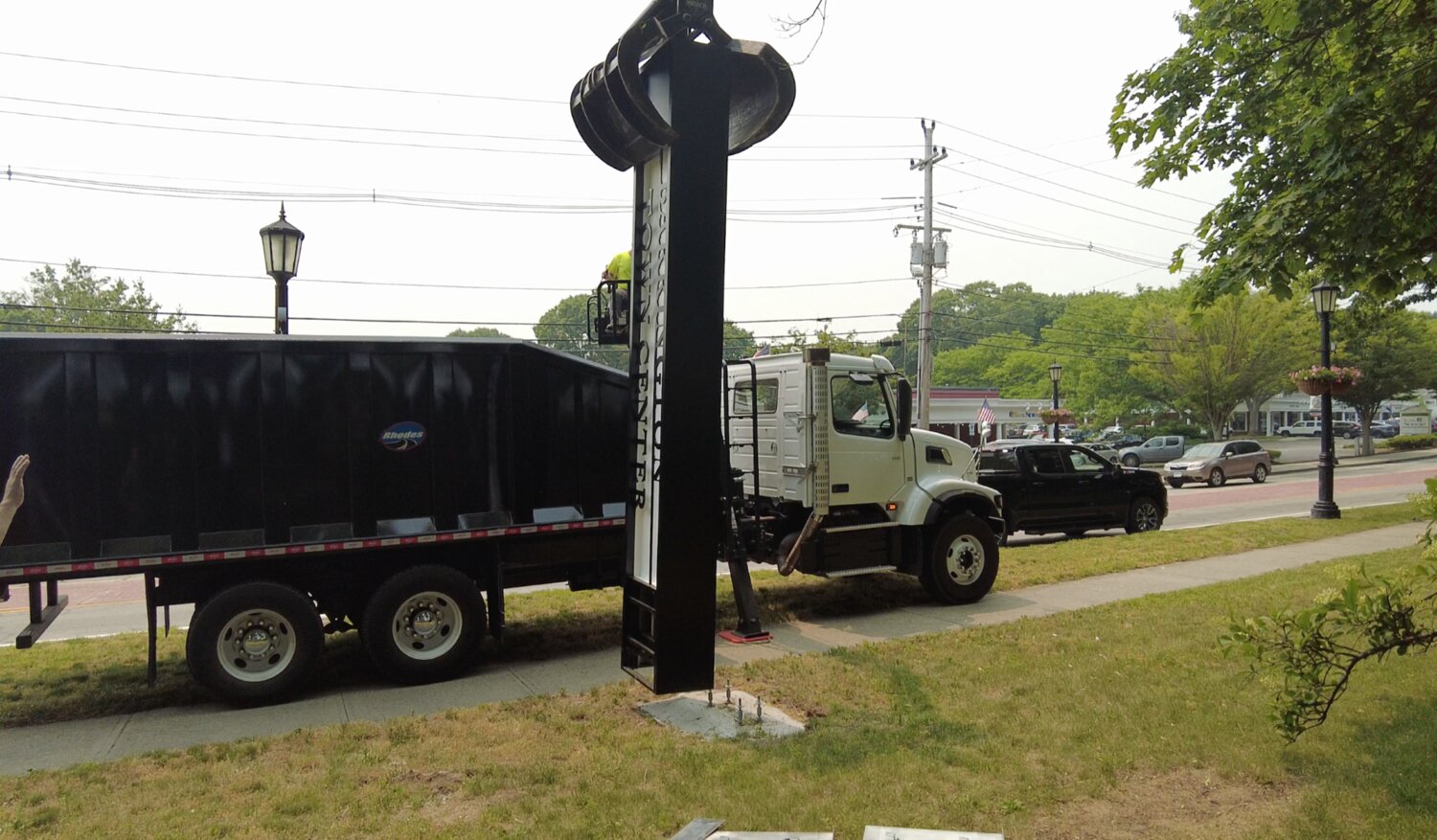 A Barrington DPW crane removes one of the “Barrington Town Center” signs on Tuesday, June 6.
