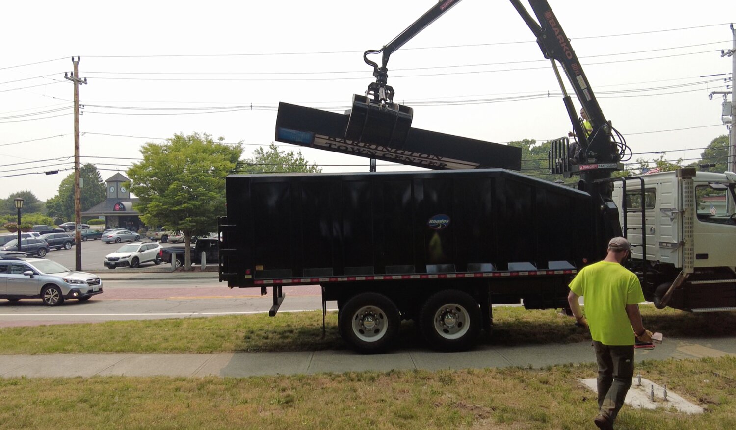 A crane lowers one of the pillar signs into the back of a Barrington DPW truck on Tuesday, June 6.
