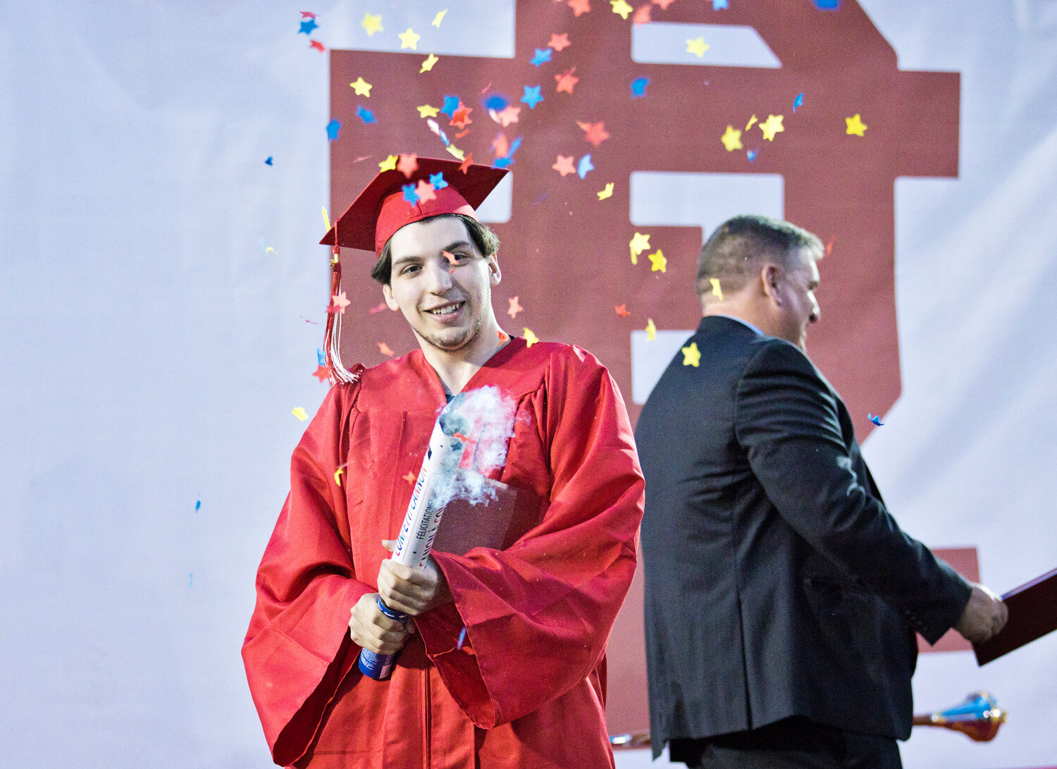 Taylor Sousa fires off a party popper after receiving his diploma.
