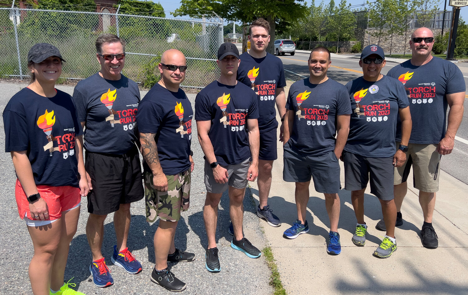 Barrington Police Officer Kelsey Maynard, Police Chief Michael Correia, Police Officers Tim Oser, Regan Jeffrey, Sean Murphy, Josh Melo and Barrington Firefighters Jesus Sanchez and Ed Owens (from left to right) gather for a group photo before participating in the annual Special Olympics torch run.