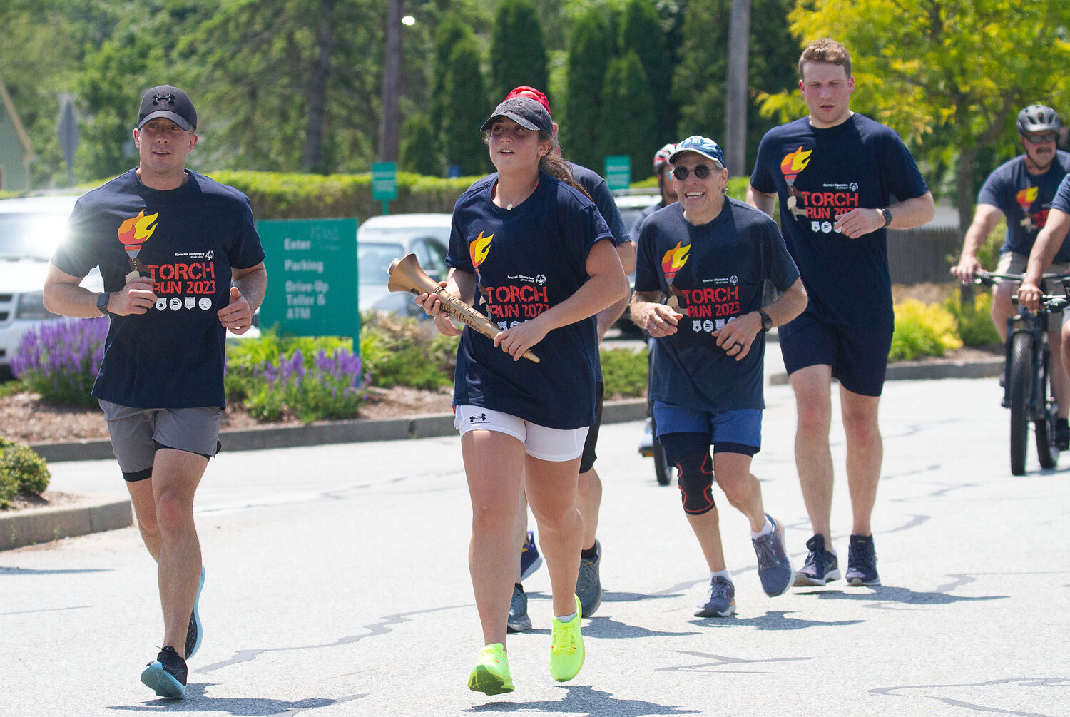 Barrington Police Officers Regan Jefferey (left), Kelsey Maynard (center) and Sean Murphy (right) carry the Special Olympics torch to East Providence, during the recent torch run.