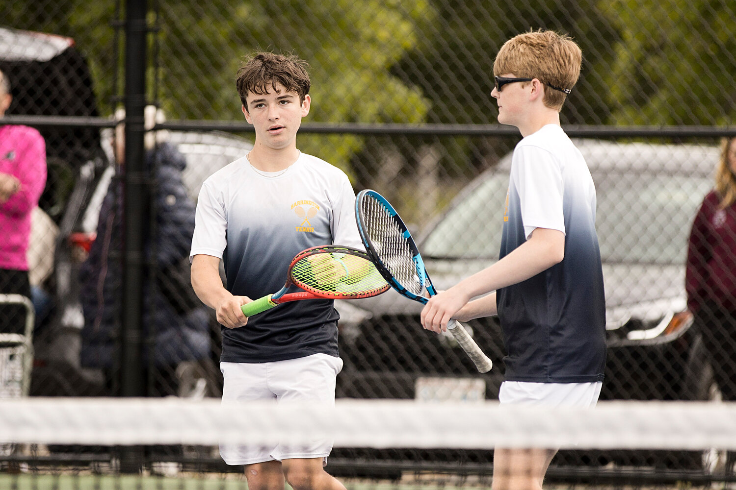 Garrett Meehan (right) and Zach Spear tap rackets after earning a point against LaSalle.