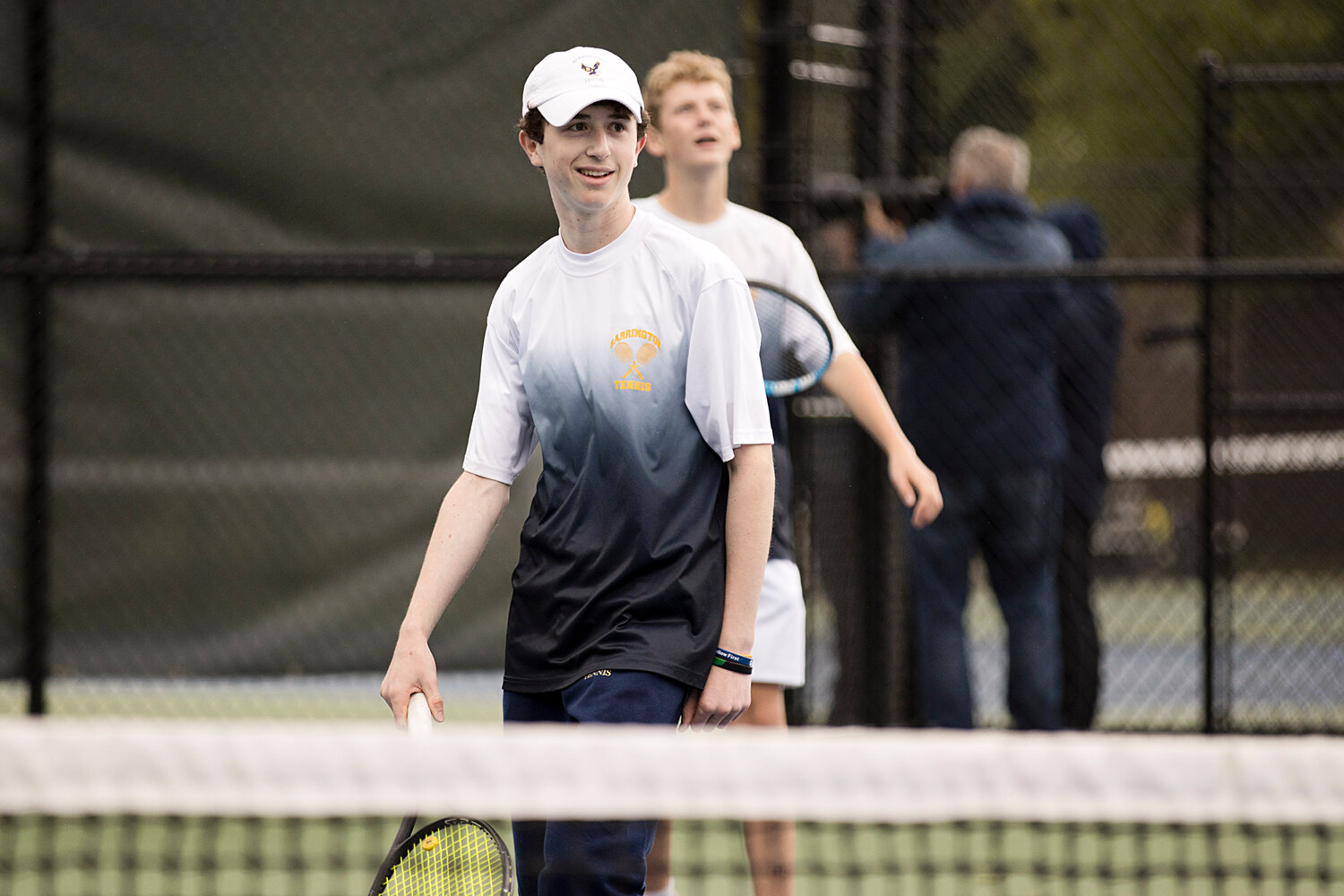 Bryce Kupperman smiles after he and teammate, Gabe Anderson, earn a point in the No. 1 doubles match.
