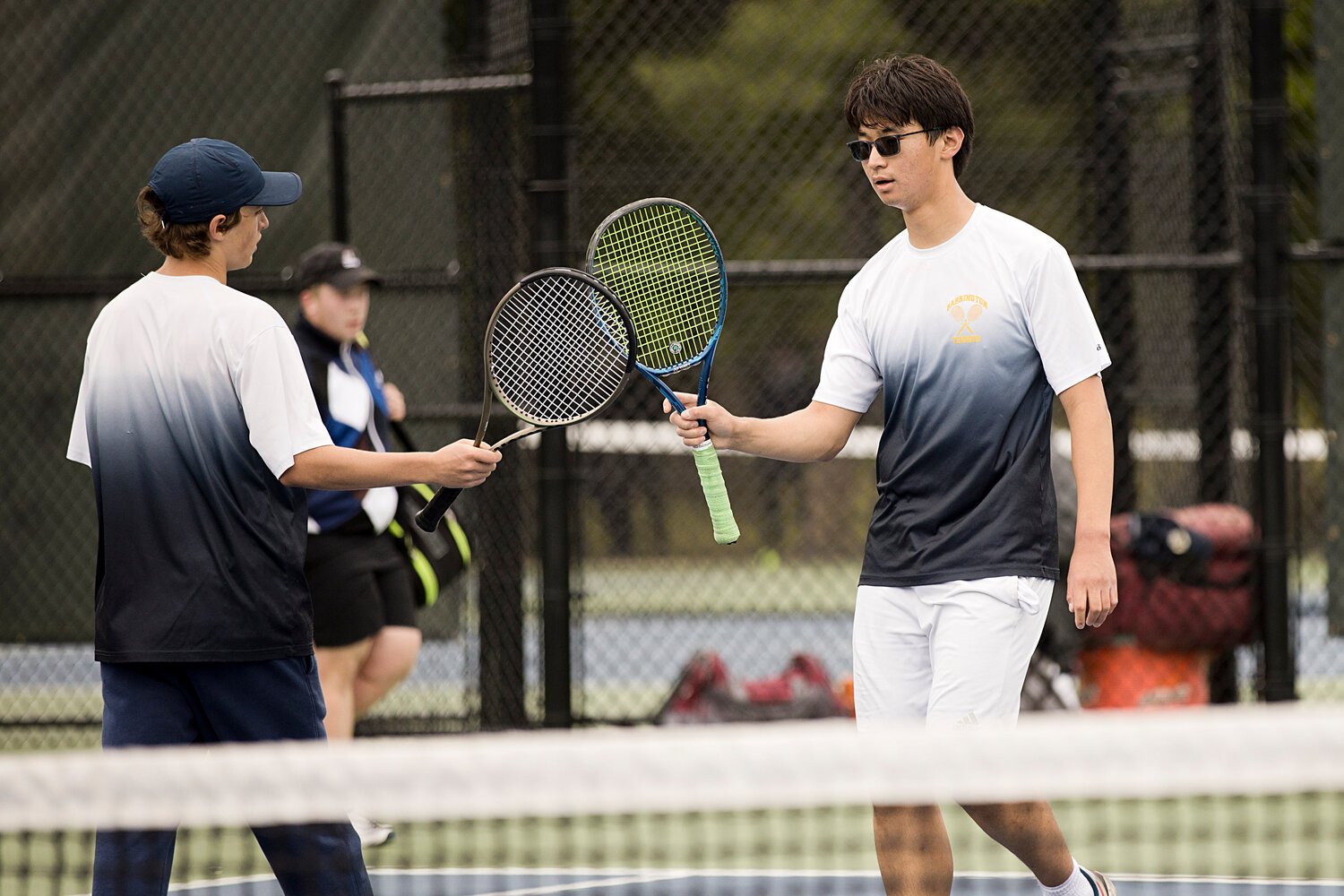 No. 2 doubles players Henry Birbiglia (left) and Dawen Cheng congratulate each other after earning a point against LaSalle.
