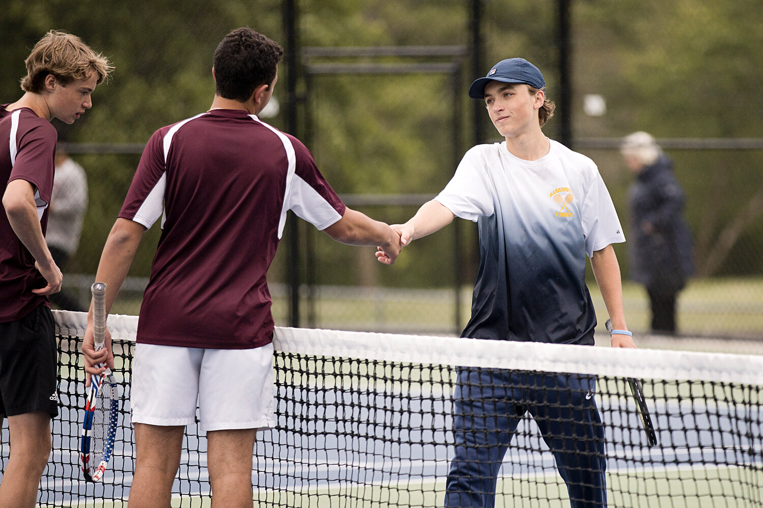 Henry Birbiglia shakes hands with LaSalle opponents after their match.