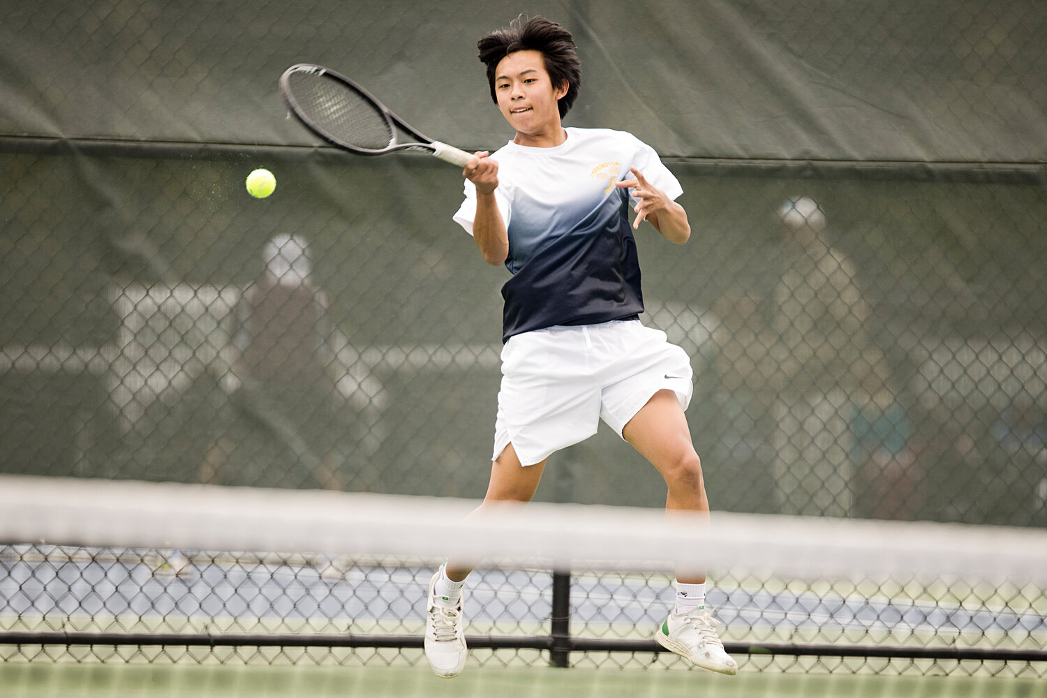 No. 3 singles player, Jeremy Kuo rallies with a LaSalle opponent during the Division I finals, Saturday.