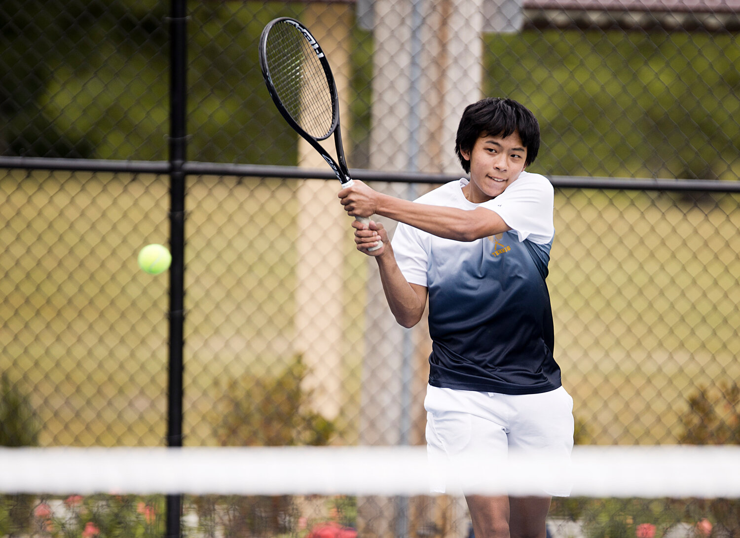 No. 3 singles player, Jeremy Kuo rallies with a LaSalle opponent during the Division I finals, Saturday.