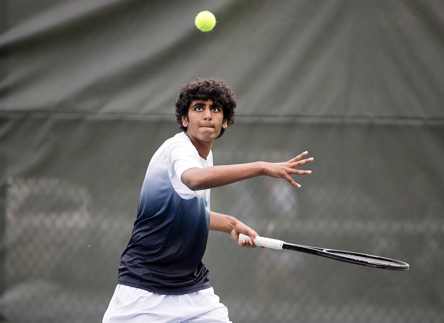 No. 4 singles player Vineet Abbineni times his swing while returning a serve to his LaSalle opponent.
