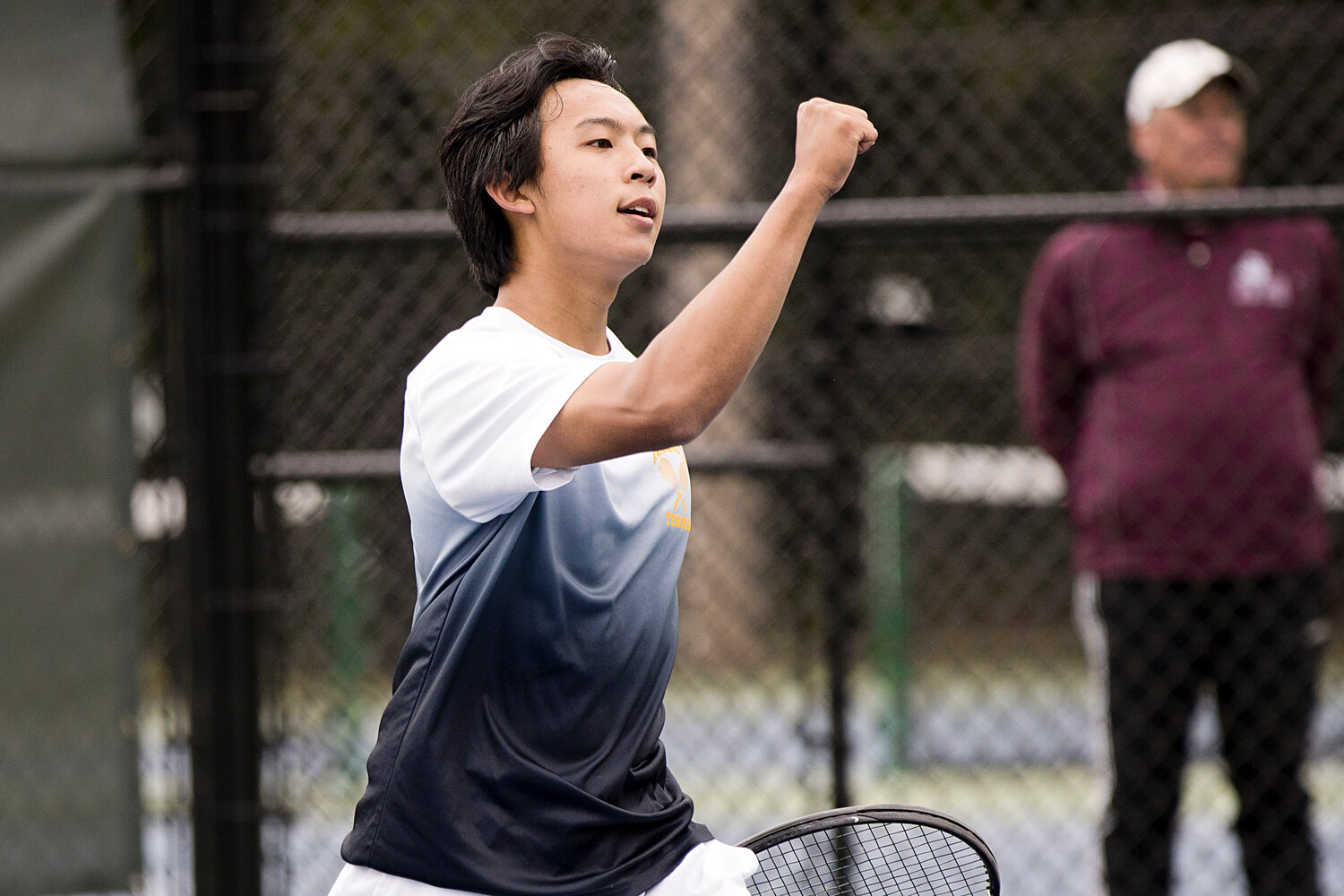 No. 3 singles player Jeremy Kuo raises a fist after beating his LaSalle opponent in the Division I semifinal match, Saturday.