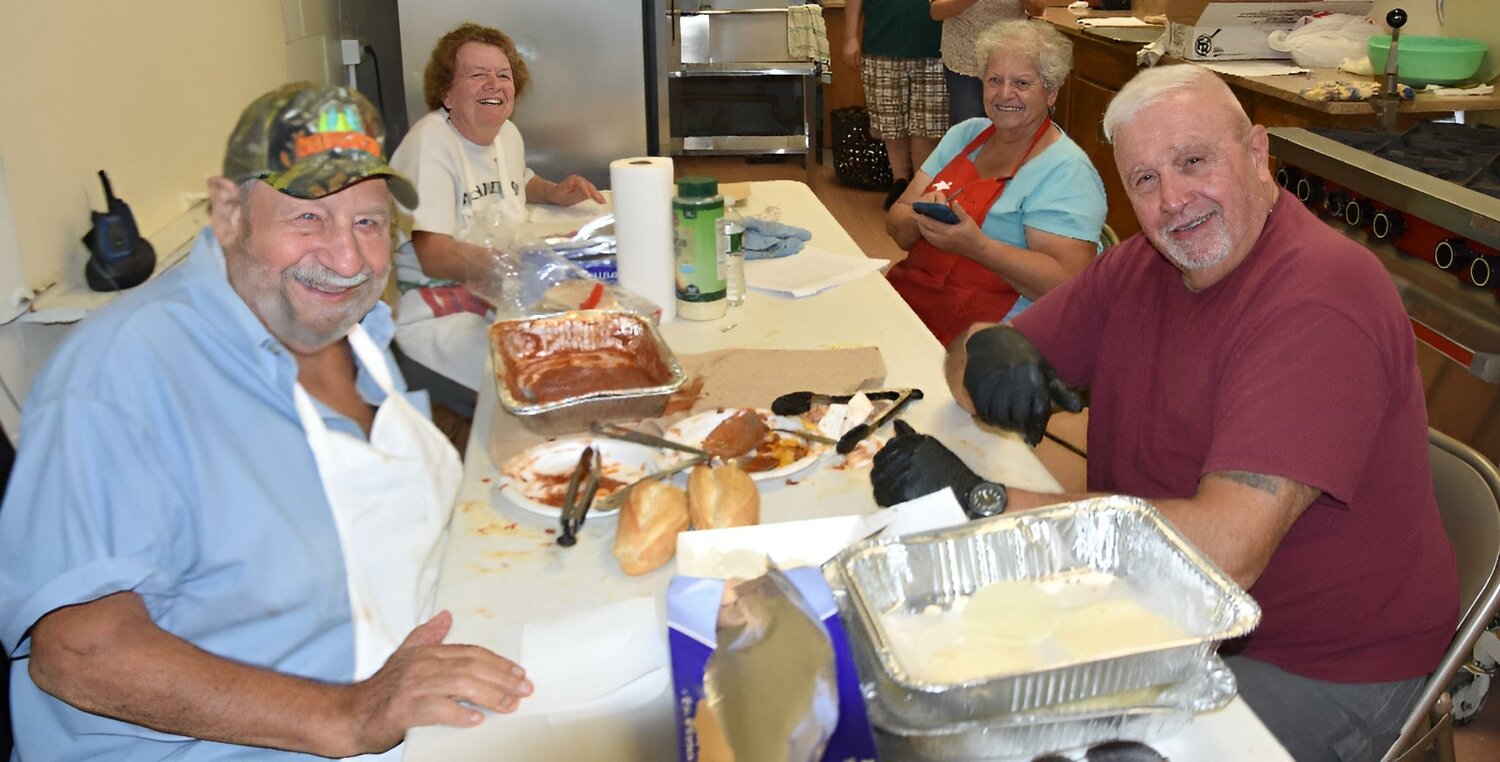 The late Joseph Pine Jr. (far right) always lent a helping hand, no matter what the situation. He particularly enjoyed working alongside his Holy Angels Church Take-Out Thursday committee members (left to right) Luigi Carusi, Carmella Carusi, and Barbara St. Angelo.