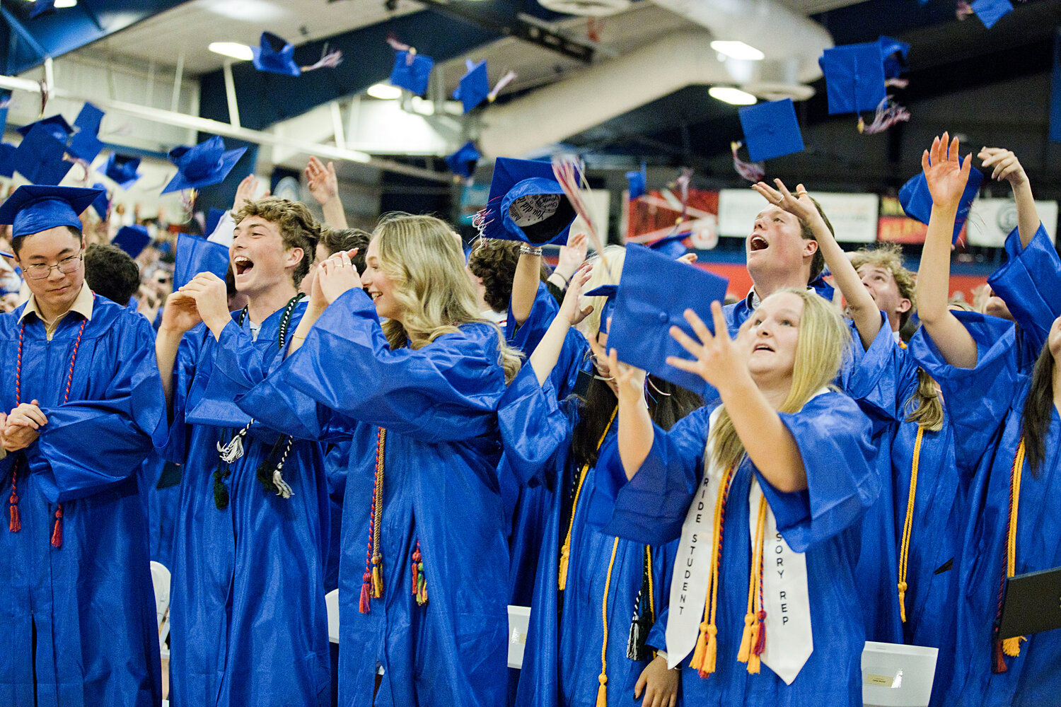 Portsmouth High seniors toss their caps at the end of Friday night’s graduation ceremony inside the PHS field house. Diplomas were awarded to 195 students.