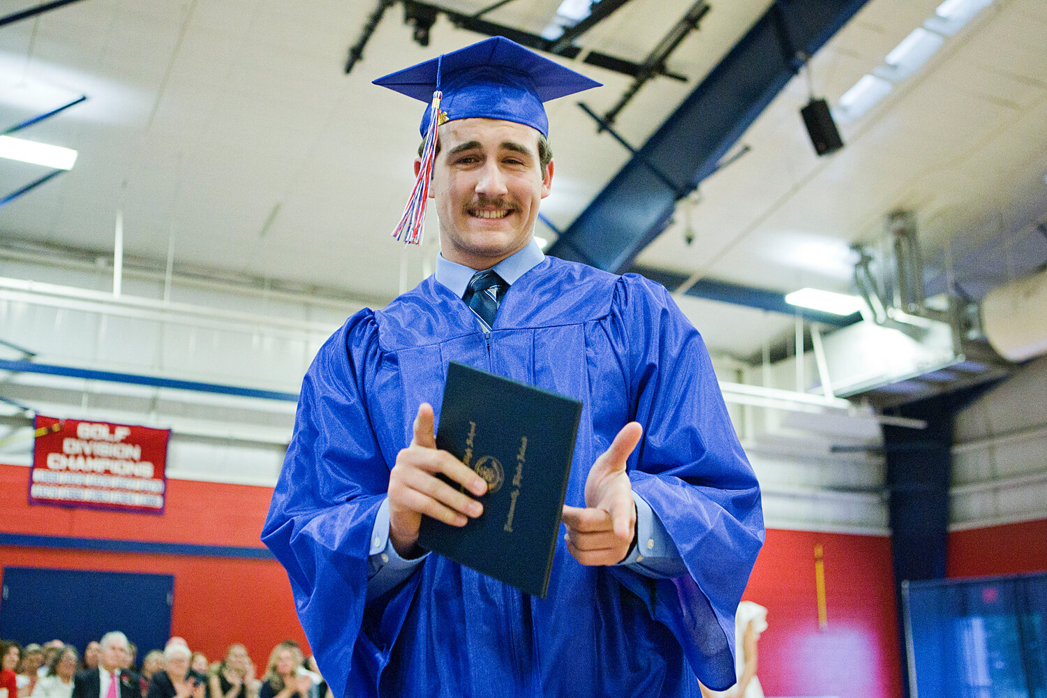 Colin Bahr mugs for the camera after collecting his diploma.