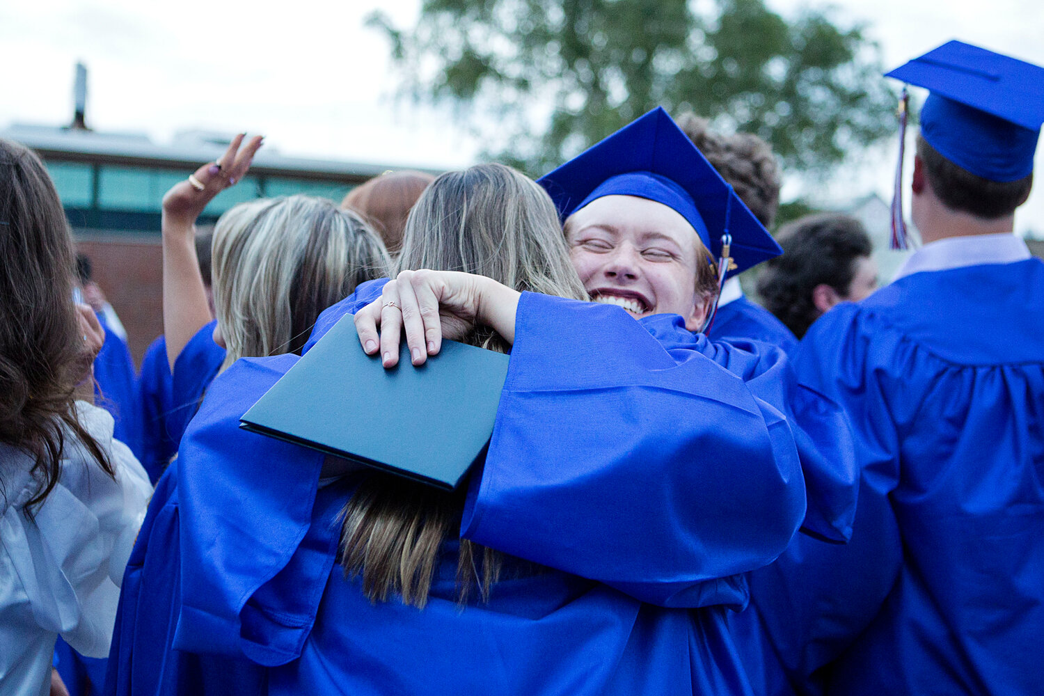 Jack Hollen gives a classmate a big squeeze following the ceremony.