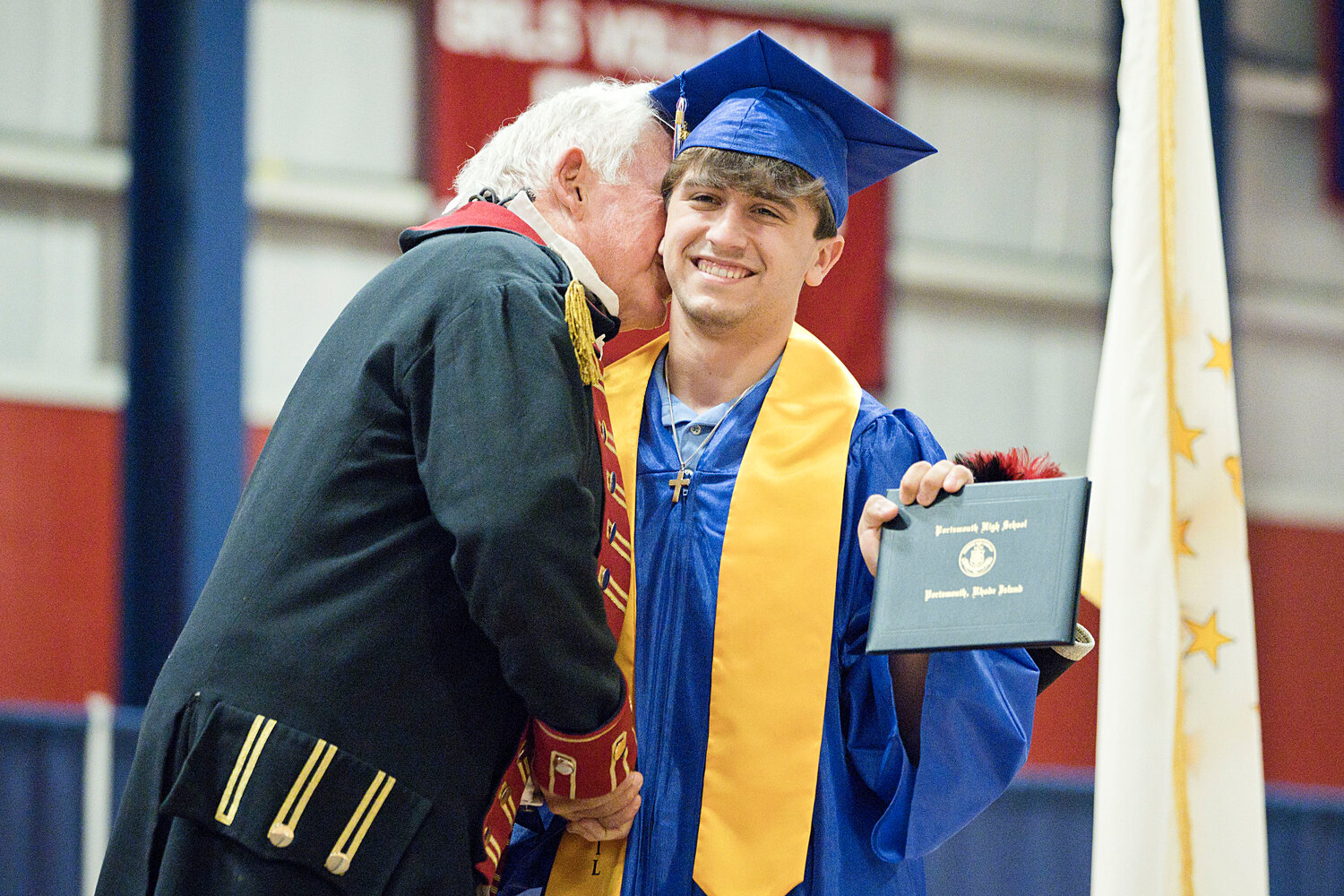 “Patriot” Robert Edenbach gives Andrew Alvanas a hug after presenting him with his diploma.