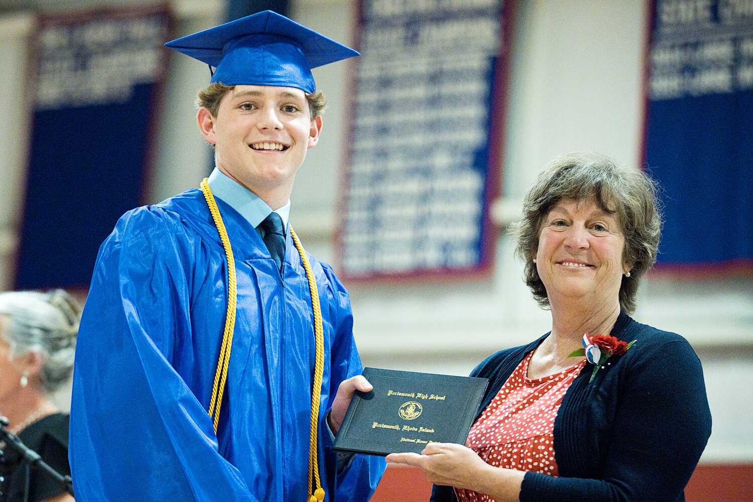 Evan Tullson of Little Compton receives his diploma from Emily Copeland, who chairs the Portsmouth School Committee.