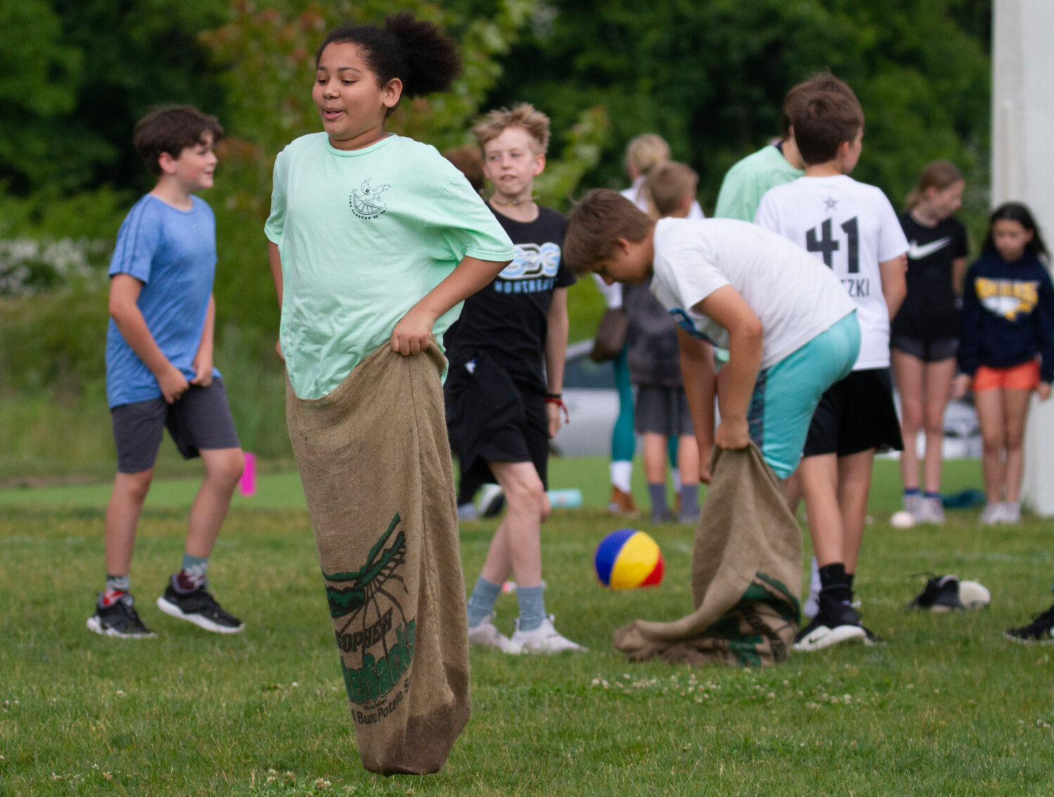 JR Breen competes in the sack race event during the Lime Cluster Field Day at Barrington Middle School on Friday.
