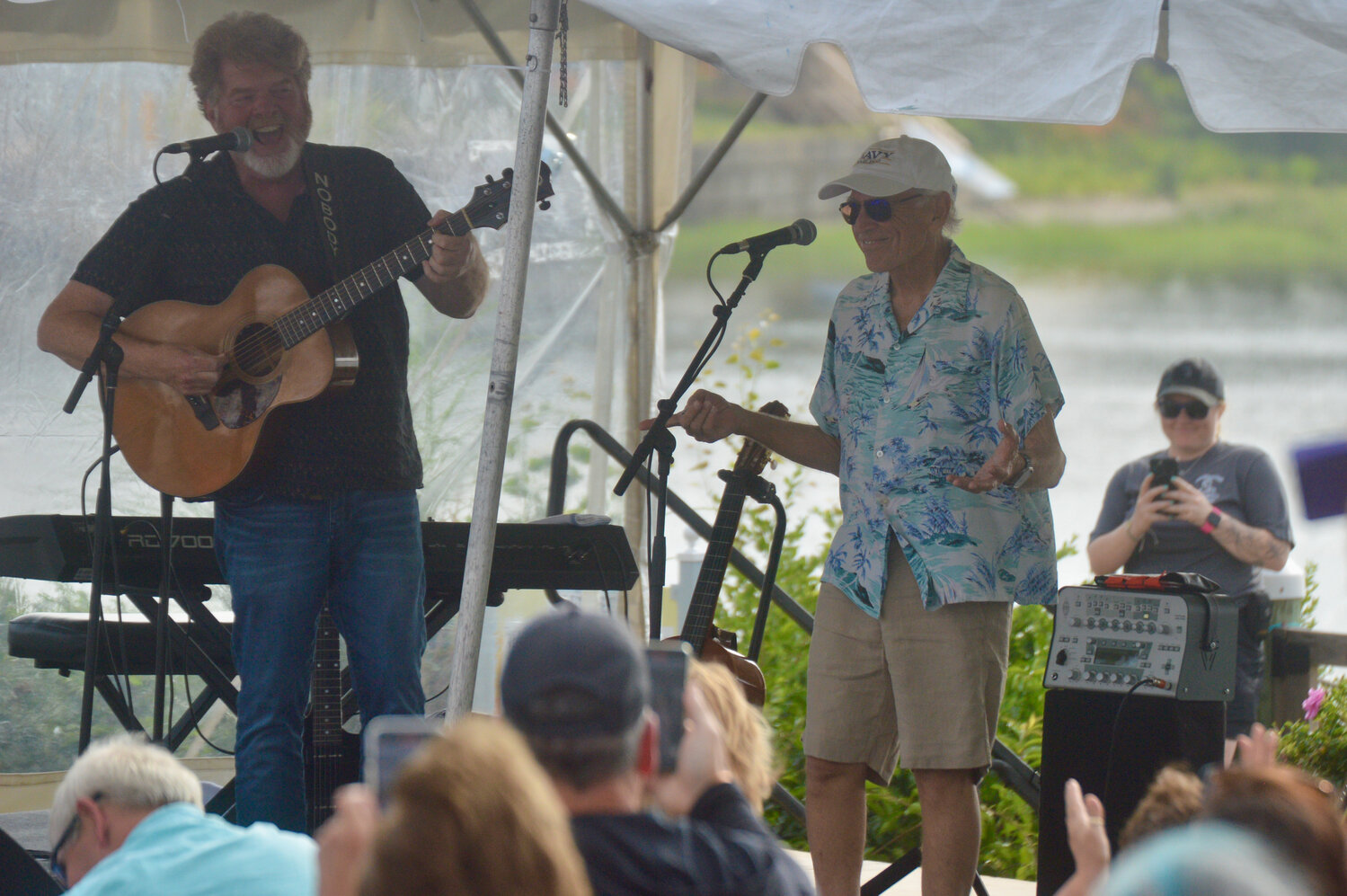 Jimmy Buffett takes to the stage to the delight of the crowd. His bandmate Mac McAnally is at left.