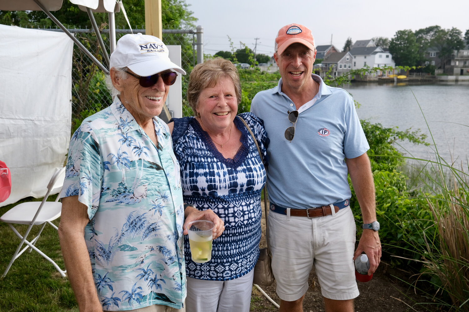 Jimmy Buffett (left) poses for a photo with Sharon MacFarlane and her son, Mike, the owner of Sunset Cove where Buffett made a surprise appearance on Sunday.