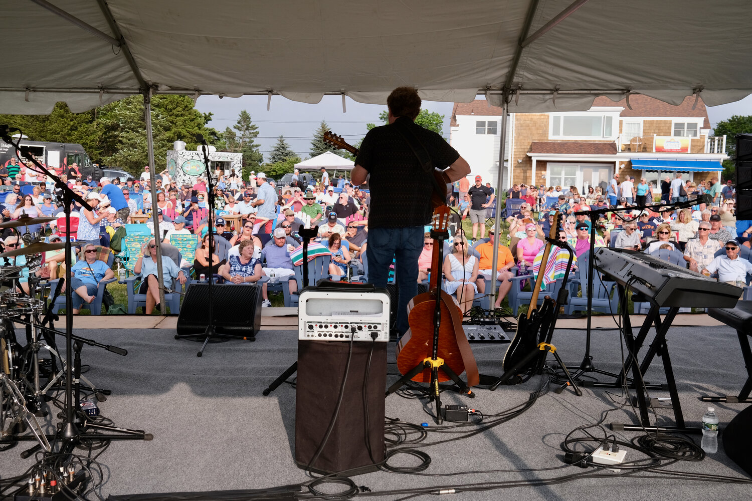 Mac McAnally performs to a lawn full of “Parrotheads” behind Sunset Cove.