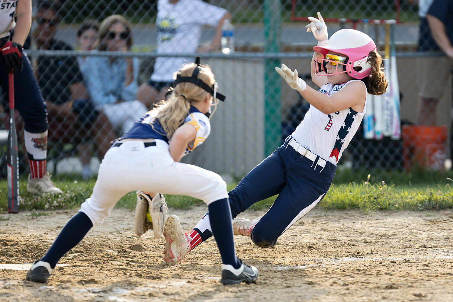 Sofie Gill slides into home plate.