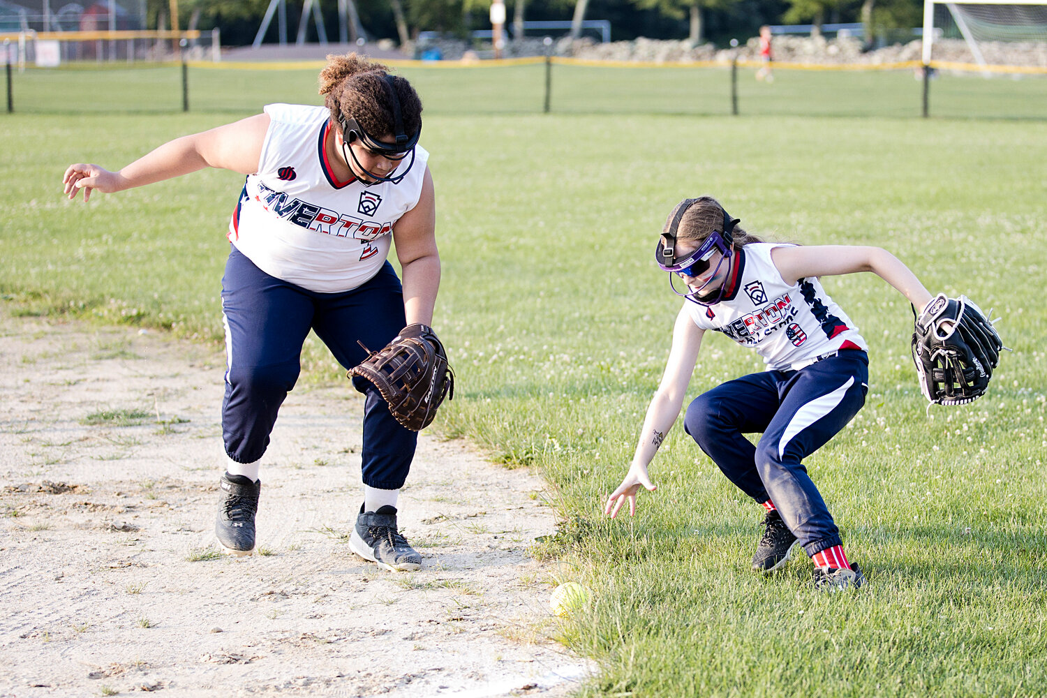 Gabi Piker (left) and Emily Martin recover a ball in right field. 