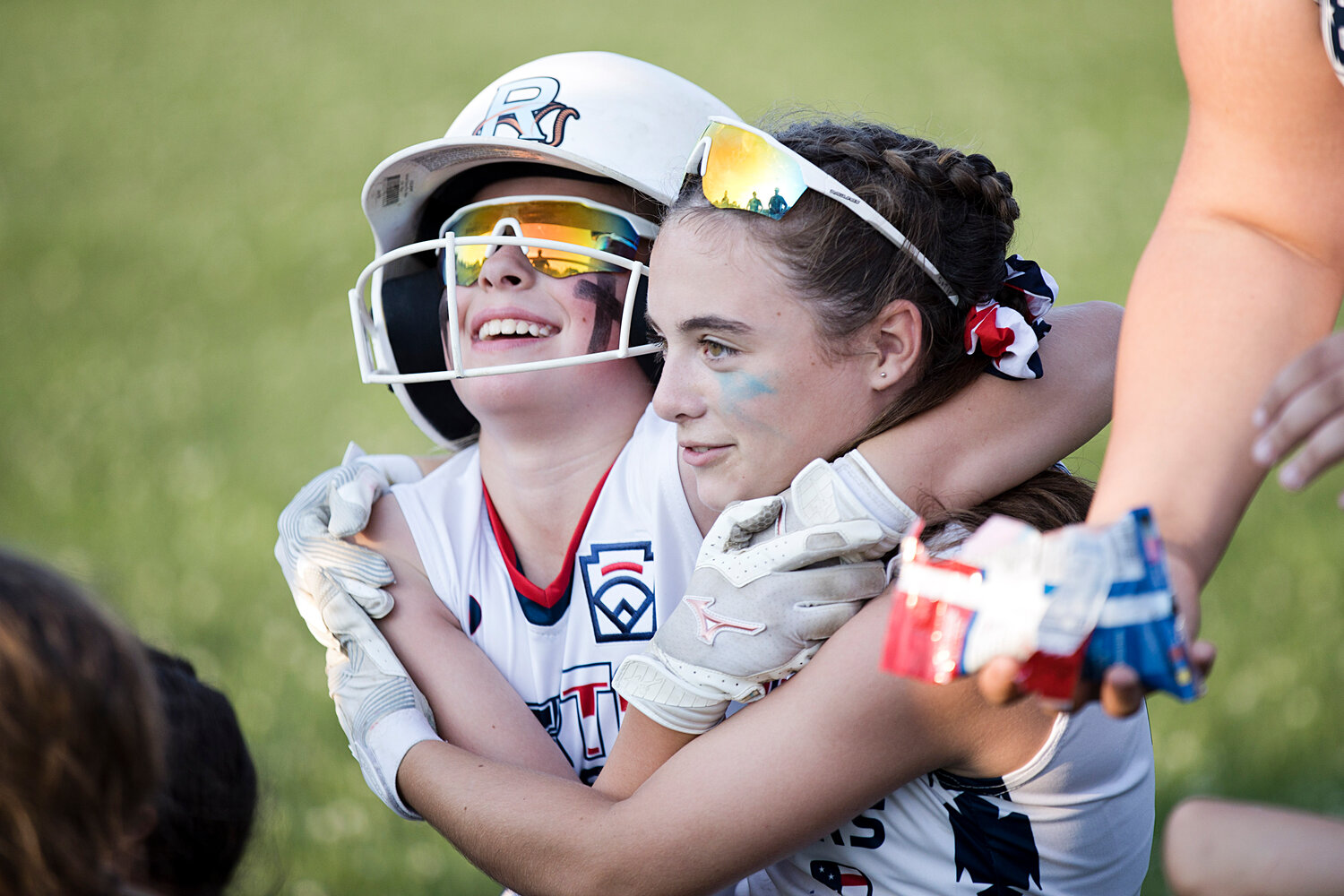 Kylie Hill and Sofie Gill share a hug after winning the district championship, Wednesday. 