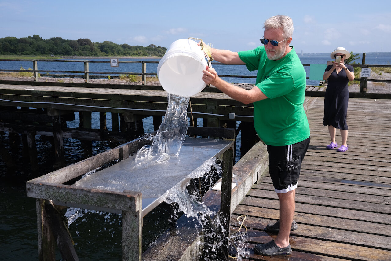 Ted washes off the fillet table on the T-Wharf, where massive Navy ships once tied up and is now a popular spot for anglers.