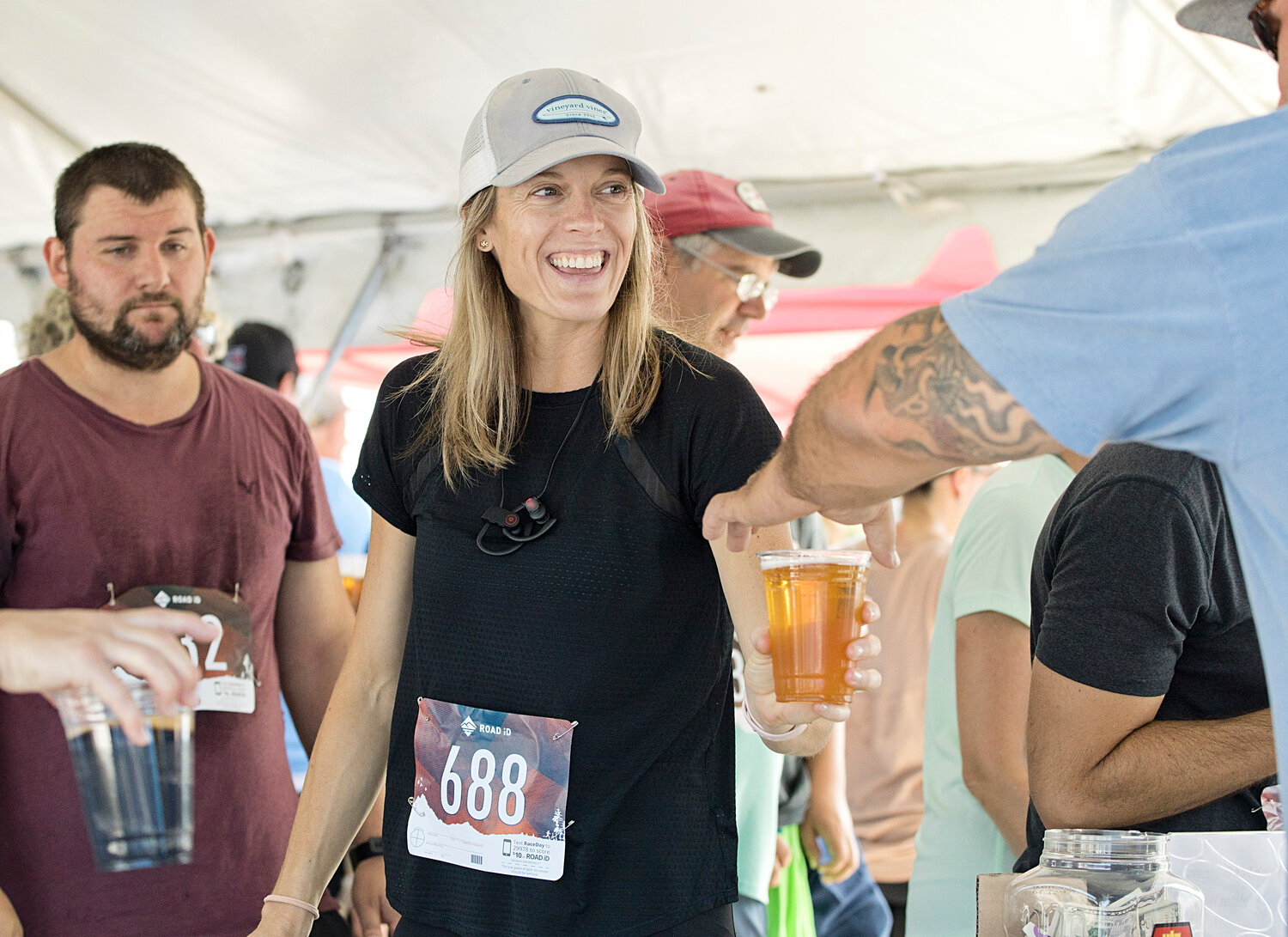 Helen Leffers, of Barrington, is offered a beer after participating in the 14th annual Finish for a Guinness 5K last year.