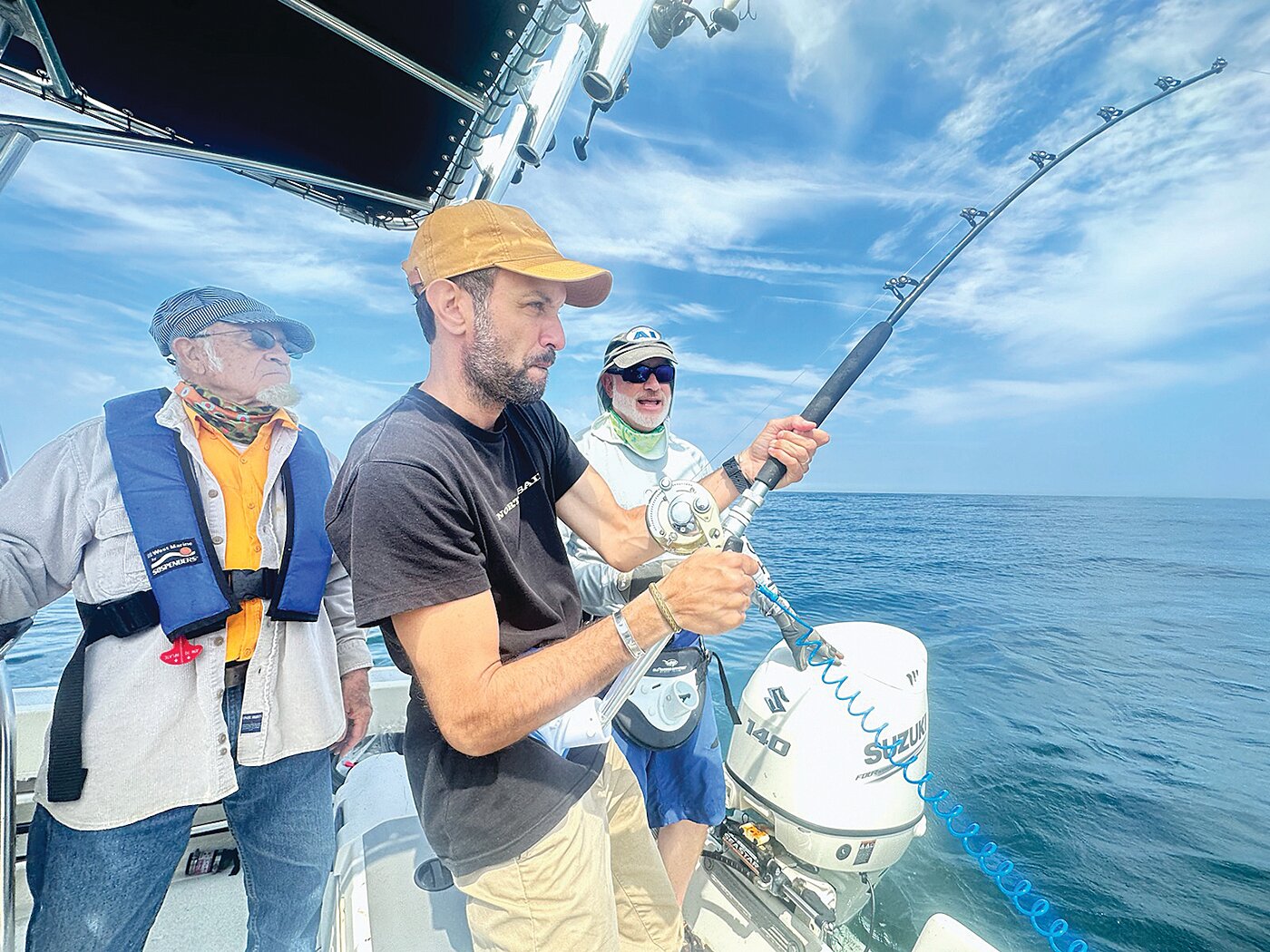 Greg Vespe at the stern, with his father Ric Vespe at the helm, as cousin Stephano Leoni reels in a thresher shark. Greg’s son Shawn Hayes Costello was also part of the crew.