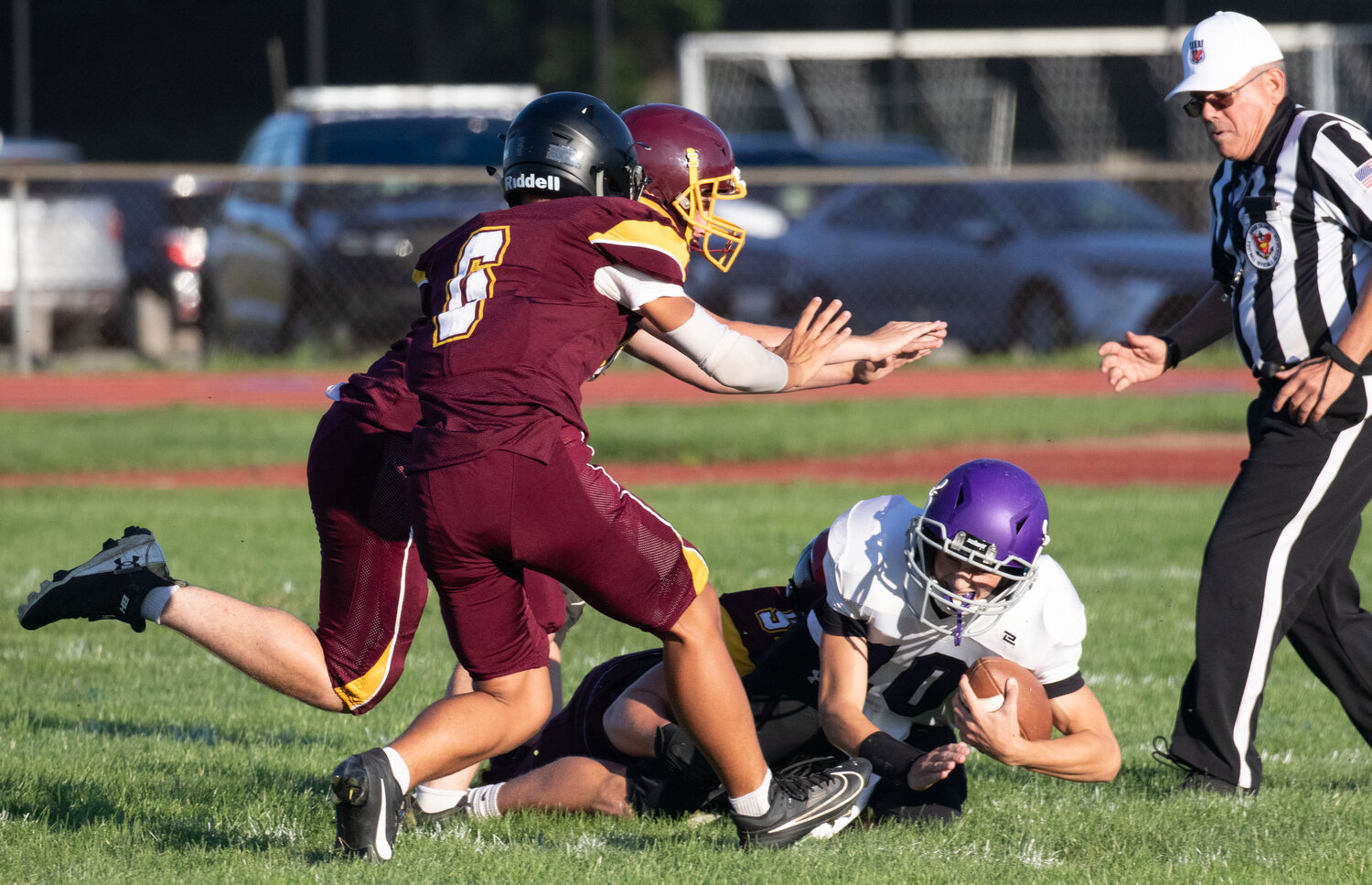 Ethan Quicksall and company tackle Huskies' quarterback Ethan Martel for a loss.