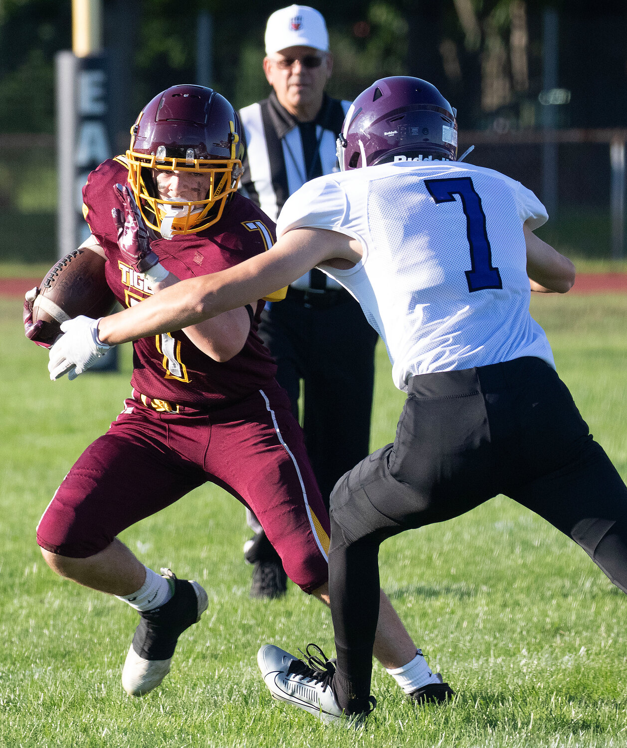 Running back Aiden Champ looks to deke a Huskies defender during an outside run.
