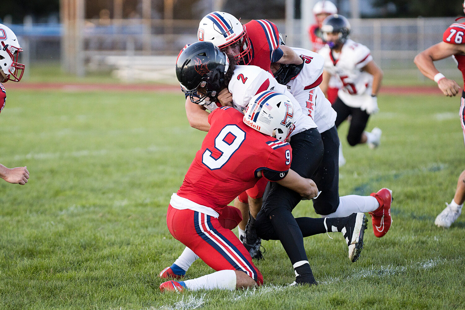 George Smith (9) and Ben Blythe sandwich a Rogers ball-carrier.