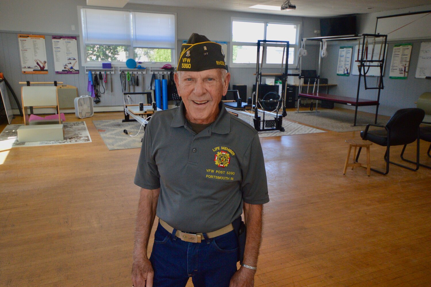 Ken Rutter, commander of VFW Post 5390 in Common Fence Point, stands inside the top floor of the hall, which is undergoing a transformation. Behind him are pilates equipment used in classes led by Conley Zani, who rents space in the building.