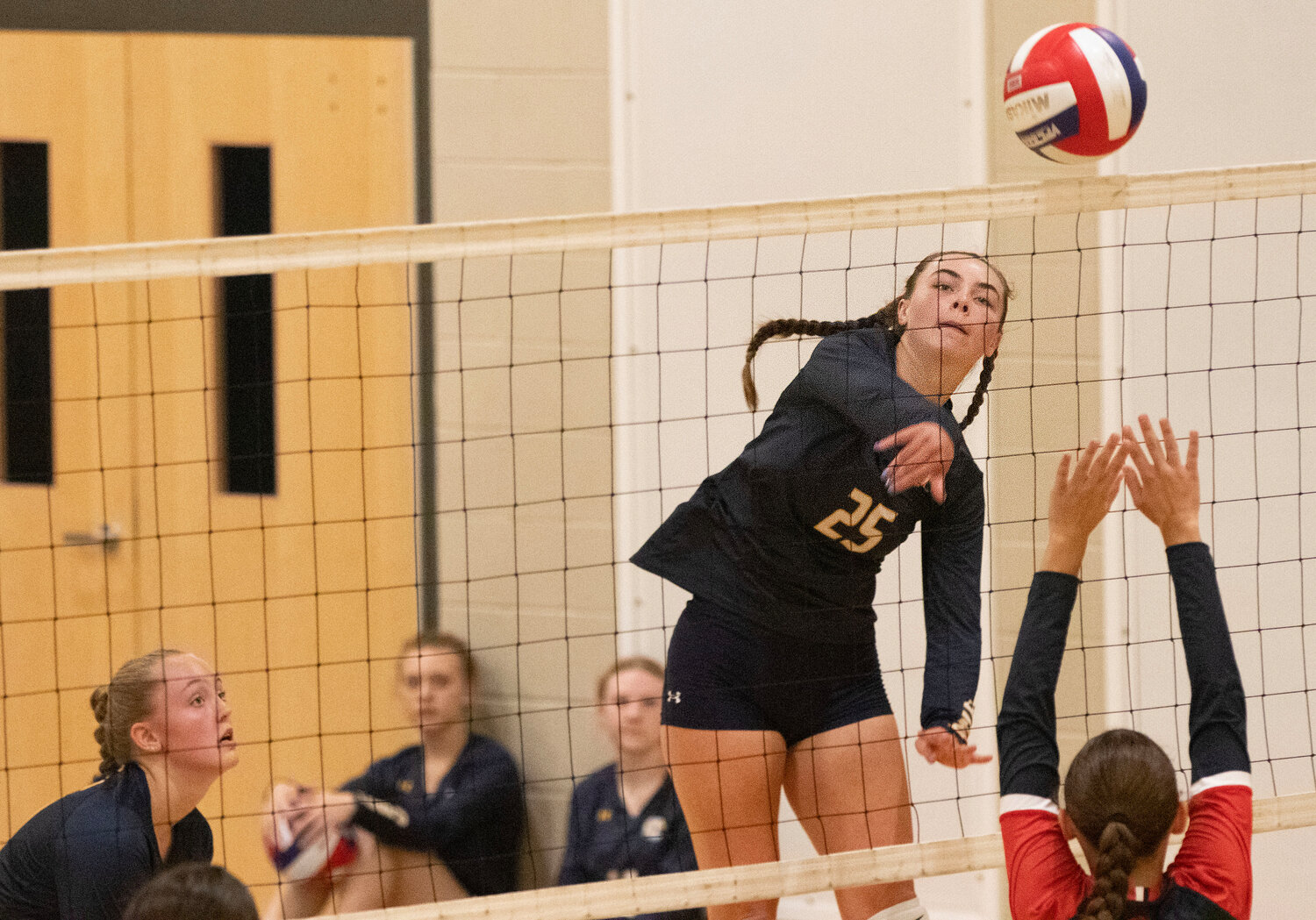 Barrington High School’s Kasey Dillon spikes the volleyball over the net against Lincoln.