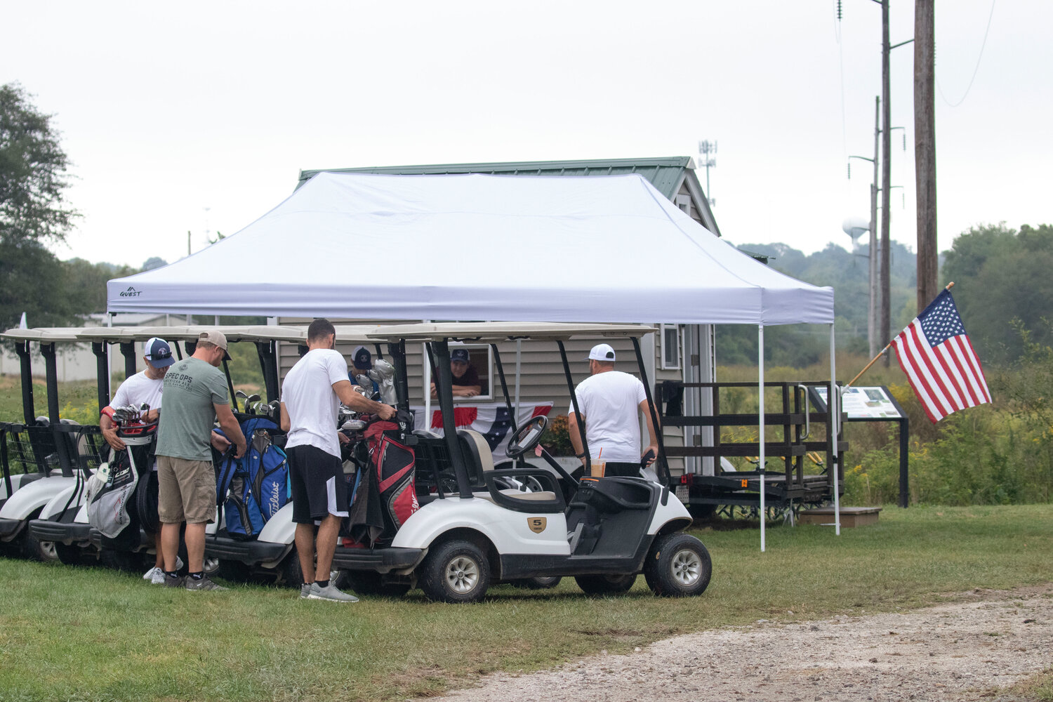 Golfers get ready at the mobile club house to go out on the greens.