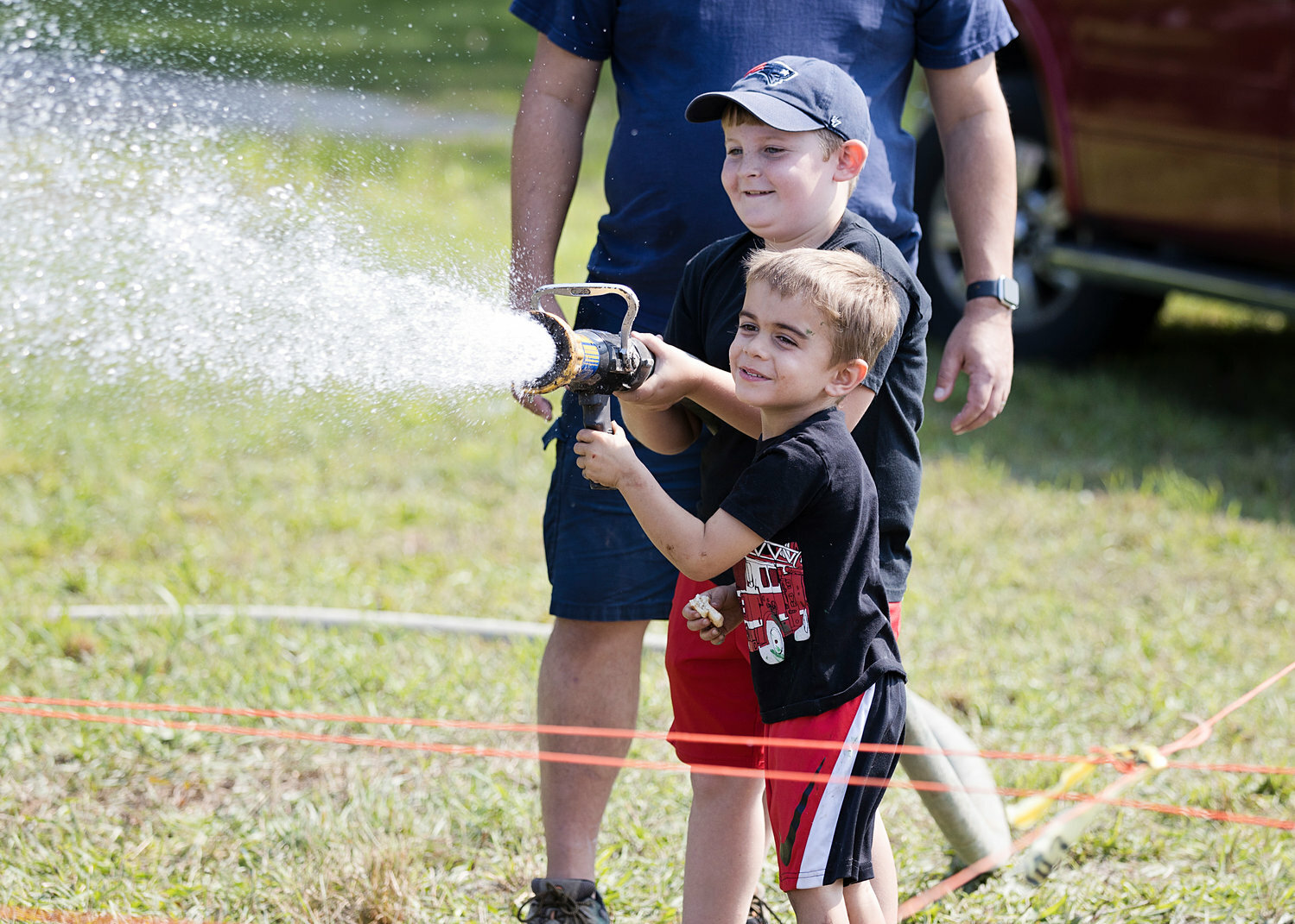 Shawn Little (in back) and Henry Sleeper help the Warren Fire Department saturate the mud at last year’s Boldrdash's "Thrive Outside in the Mud”.