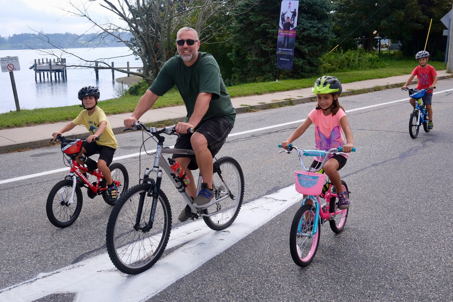 Members of the Cote family from Dartmouth pedal their bikes along Park Avenue during the inaugural Sakonnet Coastal Bike and Stroll held Saturday. Jeremy Cote leads his children (from left) Jack, 8, Georgia, 6, and Sam, 6. Park Avenue, Hummocks Avenue and a portion of Anthony Road into Common Fence Point were shut down to motor vehicles so cyclists and pedestrians could enjoy a safe, car-free ride.