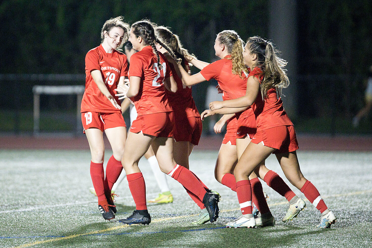 The Patriots celebrate a goal scored by Kaelyn Mahoney late in the first half of Tuesday’s home game against North Smithfield. Portsmouth won, 2-0.