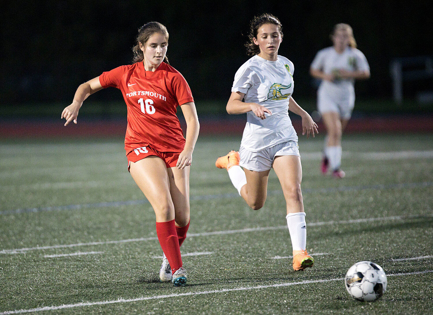 Evelyn Shuster kicks the ball ahead of a North Smithfield opponent.