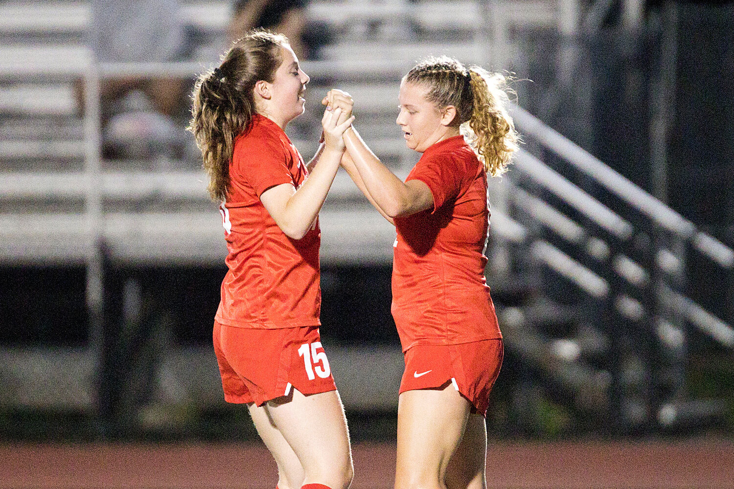 Kaelyn Mahoney (left) and Mollyana McGuire celebrate after a shot from McGuire finds the back of the net in the first half of Tuesday’s game against North Smithfield.