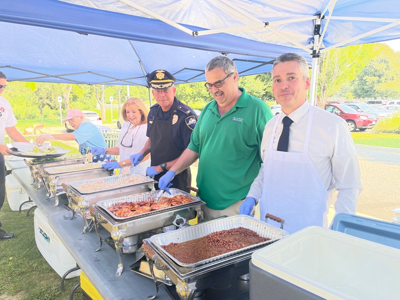 (R-l) Town Administrator Steve Contente, Parks and Recreation Director Warren Rensehausen, Police Chief Kevin Lynch, State Rep. Susan Donovan and Diane Davis kept the trays of food (a delicious barbecue chicken lunch donated by the Common Pub) coming.